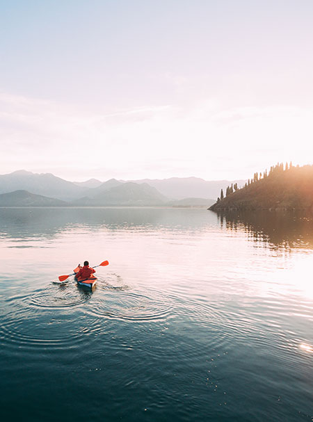 person kayaking in lake tahoe