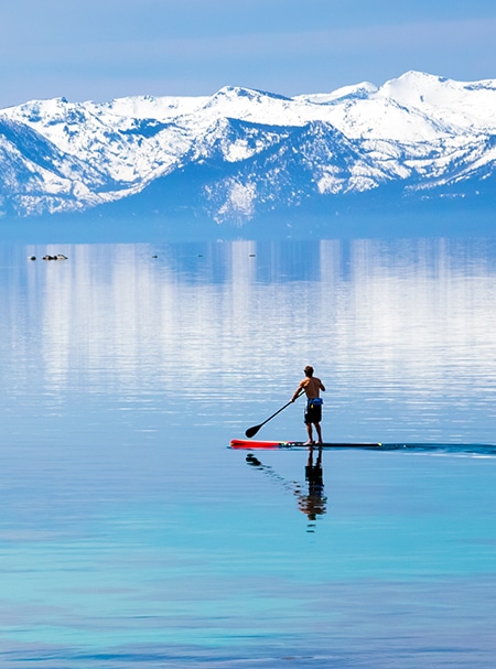 man paddleboarding on lake tahoe