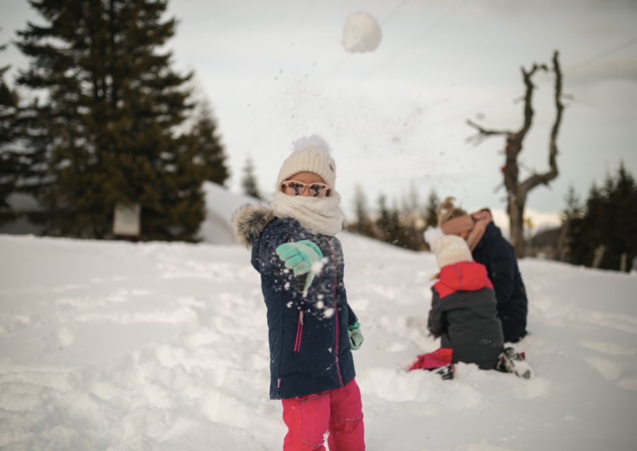 child throwing snowball